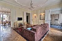 elegant living area and dining room with a six-seater dining set in a 3-bedroom Paris luxury apartme