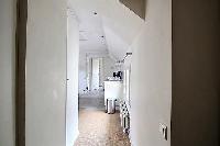 clean hallway and white kitchne in a 2-bedroom Paris luxury apartment