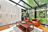 sitting room with two armchairs and a center table in a 2-bedroom paris luxury apartment