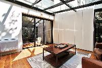 sitting room with two armchairs and a center table in a 2-bedroom paris luxury apartment