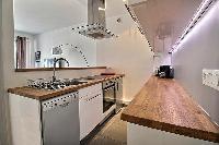 small yet fully-equipped kitchen in a 3-bedroom Paris luxury apartment