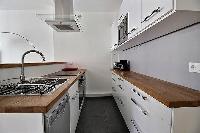 small yet fully-equipped kitchen in a 3-bedroom Paris luxury apartment