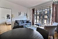 living area with a sofa with access to the bedroom in a 3-bedroom Paris luxury apartment