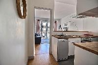 small yet fully-equipped kitchen in a 3-bedroom Paris luxury apartment