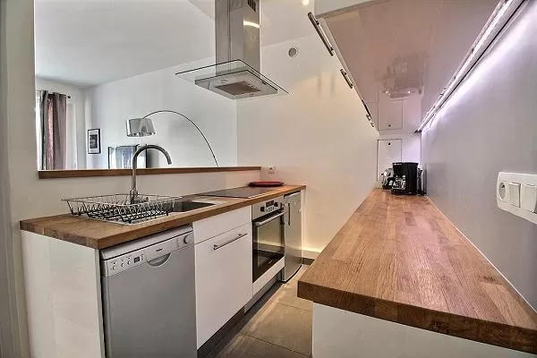 small yet fully-equipped kitchen in a 3-bedroom Paris luxury apartment