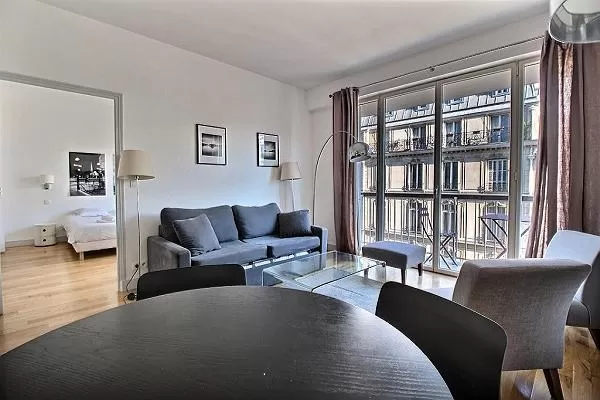 living area with a sofa with access to the bedroom in a 3-bedroom Paris luxury apartment