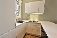 space-efficient, open-plan kitchen in a 2-bedroom Paris luxury apartment