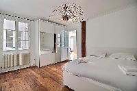 comfortable bedroom with a Queen size bed in a 3-bedroom Paris luxury apartment