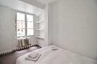 third bedroom with closets and a sofa that folds out into a double bed in a 3-bedroom Paris luxury a