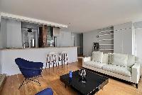 a large and open kitchen and living in a 3-bedroom Paris luxury apartment