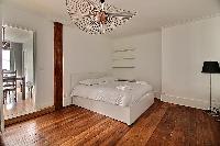 comfortable bedroom with a Queen size bed in a 3-bedroom Paris luxury apartment