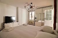 comfortable bedroom with a Queen size bed in a 3-bedroom Paris luxury apartment