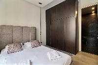 bedroom with a queen size bed in a 2-bedroom Paris luxury apartment