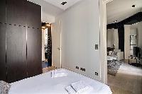 bedroom with a queen size bed in a 2-bedroom Paris luxury apartment