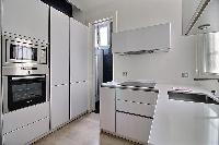 fully equipped semi-separated kitchen in a 2-bedroom Paris luxury apartment
