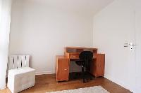 bedroom with working desk and chair in a 3-bedroom Paris luxury apartment