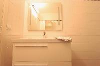 bathroom with sink and mirror  in a 3-bedroom Paris luxury apartment