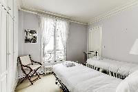 Second Bedroom with two single beds and more closet space in a 2-bedroom Paris luxury apartment