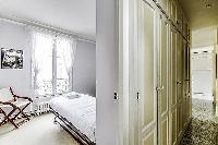 Second Bedroom with two single beds and more closet space in a 2-bedroom Paris luxury apartment