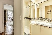 second bathroom with a shower and a sink in a 2-bedroom Paris luxury apartment