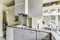 a grand fully-equipped kitchen that is large for Parisian standards in a 2-bedroom Paris luxury apar