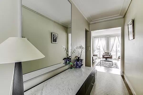 elegant hallway with lamp and mirror in a 2-bedroom Paris luxury apartment
