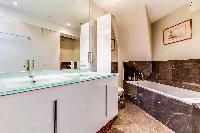 neat and fresh bathroom with tub in Louvre Palais Royal IV luxury apartment