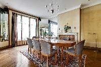 dining room for eight with a long table and chandelier in paris luxury apartment