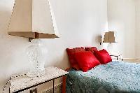 a styish lamp beside the bed in a 3-bedroom paris luxury apartment