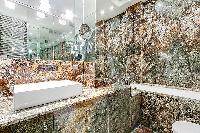 cozy bathroom with bathtub, shower, toilet, and bidet in a 3-bedroom paris luxury apartment