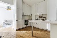 clean and white Kitchen in a 1-bedroom Paris flat