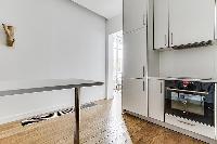 clean and white Kitchen in a 1-bedroom Paris flat