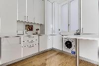 clean and white Kitchen in a 1-bedroom Paris flat