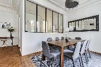 open dining room with a beautiful antique table that can seat up to eight guests  in a 2-bedroom Par
