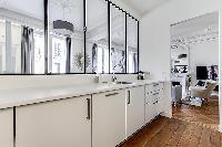 semi-open kitchen view-able by windows  in a 2-bedroom Paris luxury apartment