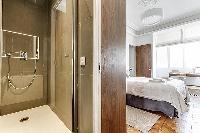 master bedroom and master bathroom with standing shower in Paris luxury apartment