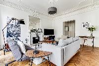 Living room with Haussman ornate ceilings, long French windows, original wooden floors and decorativ