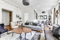 Living room with Haussman ornate ceilings, long French windows, original wooden floors and decorativ