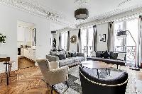 Living room with Haussman ornate ceilings, long French windows, original wooden floors and decorativ