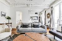 Living room with Haussman ornate ceilings, long French windows, original wooden floors and decorativ