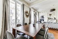 open dining room with a beautiful antique table that can seat up to eight guests  in a 2-bedroom Par