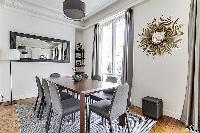 open dining room with a beautiful antique table that can seat up to eight guests  in a 2-bedroom Par