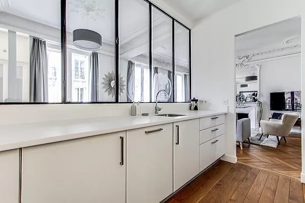 semi-open kitchen view-able by windows  in a 2-bedroom Paris luxury apartment