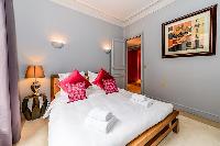 third bedroom with comfortable sleeping amenities and plenty of closets in a 3-bedroom Paris luxury 