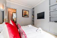 third bedroom with comfortable sleeping amenities and plenty of closets in a 3-bedroom Paris luxury 