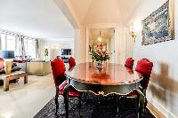 stylish dining table and 4 seats in a 3-bedroom Paris luxury apartment