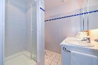 an en suite bathroom with shower and toilet in paris luxury apartment