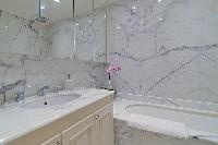 bathroom with marble lavatory and bathtub in paris luxury apartment