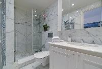 bathroom with marble lavatory, shower, and toilet in paris luxury apartment