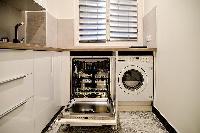 fully-equipped kitchen, a washer, and a dryer in a 2-bedroom Paris luxury apartment